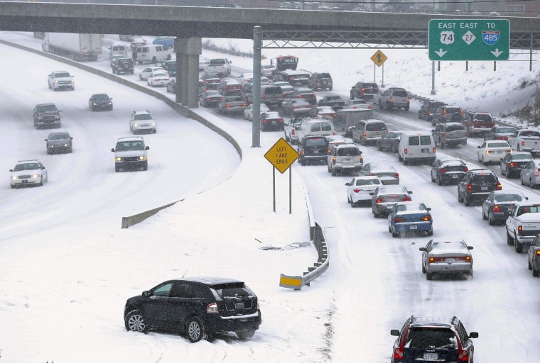 Image: Slow-moving motorists on a freeway leaving downtown Charlotte on Wednesday