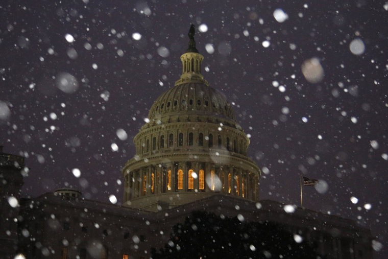 Image: A general view of the U.S. Capitol in early morning snow in Washington