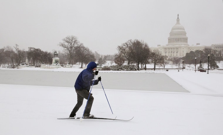 Image: A cross country skier braves the cold and snow near the U.S. Capitol Building on Thursday.