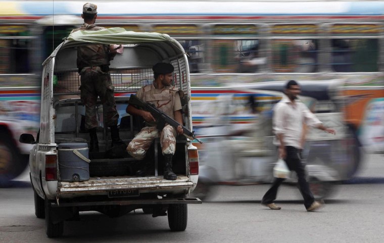 Image: Rangers keep guard at an intersection in Karachi, Pakistan