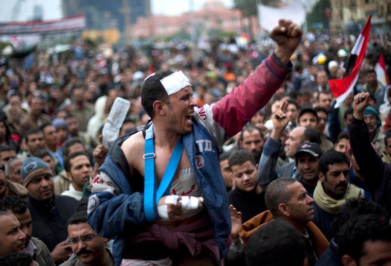Image: Anti-Mubarak protesters shout slogans during a demonstration in Tahrir square in Cairo