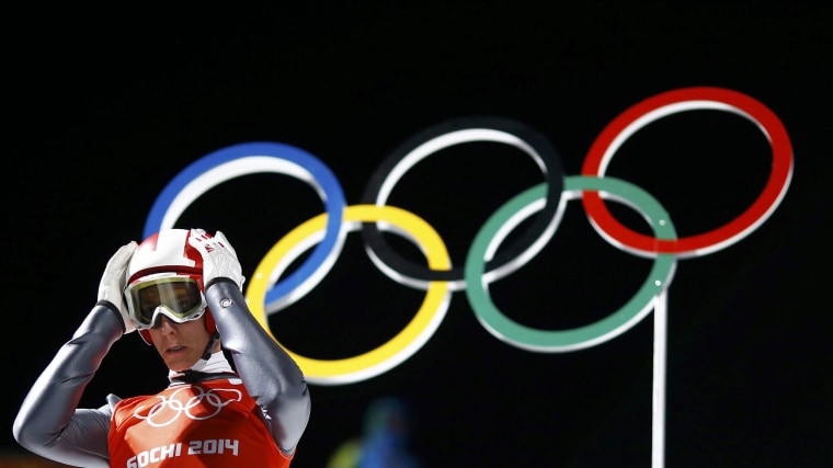 Image: Austria's Schlierenzauer adjusts his helmet as he prepares to jump during a training session for the men's ski jumping large hill individual event during the Sochi 2014 Winter Olympic Games