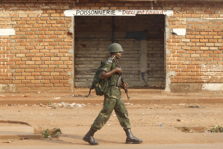 Image: A Democratic Republic of the Congo soldier, part of an African peacekeeping force, patrols beside a looted shop in Bangui