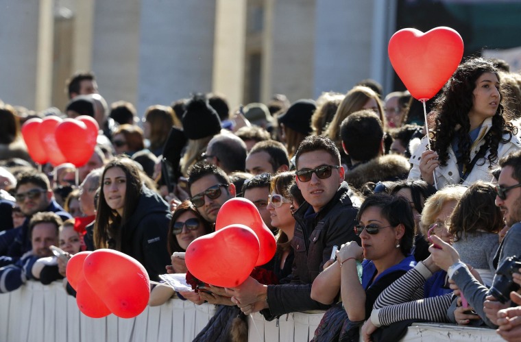 Image: Faithful hold heart-shaped balloons as Pope Francis leads a special audience with engaged couple, to celebrate Saint Valentine's day, in Saint Peter