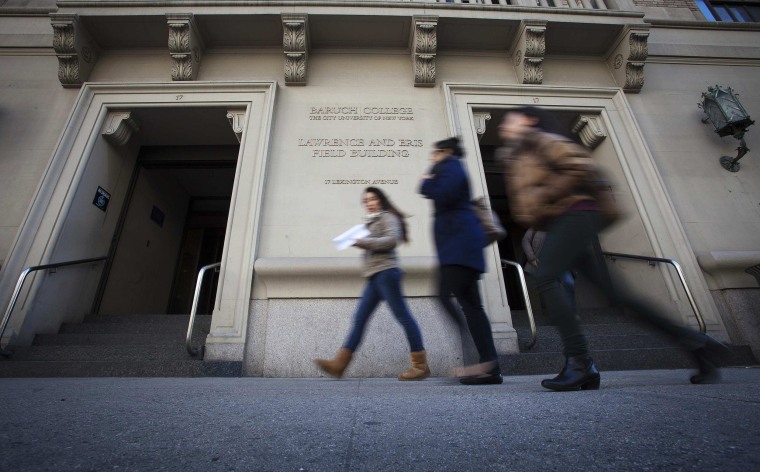 Image: People walk past Baruch College in New York