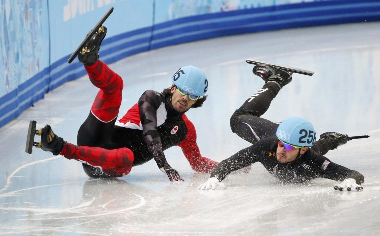Image: Canada's Charles Hamelin and Eduardo Alvarez of the U.S. fall during the men's 1,000 metres short track speed skating quarter-finals race at the Iceberg Skating Palace at the Sochi 2014 Winter Olympic Games