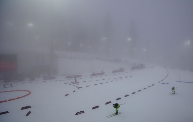 Image: Athletes ski through the fog as the men's biathlon 15K mass start race was postponed due to the lack of visibility at the 2014 Winter Olympics, Sunday, Feb. 16, 2014, in Krasnaya Polyana, Russia