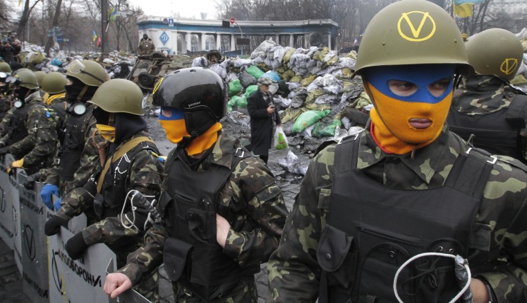 Image: Anti-government activists guard the barricade in central Kiev, Ukraine, Sunday, Feb. 16, 2014
