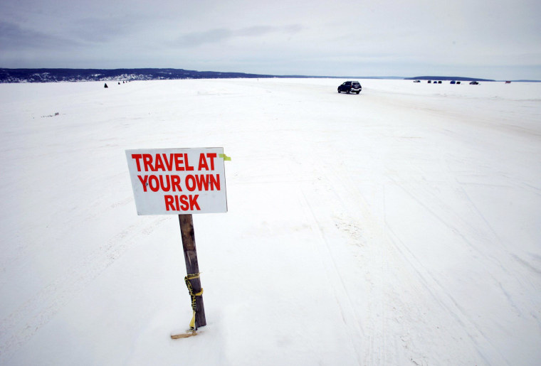 Image: Car travels the ice road on Lake Superior between Bayfield, Wisconsin and Madeline Island