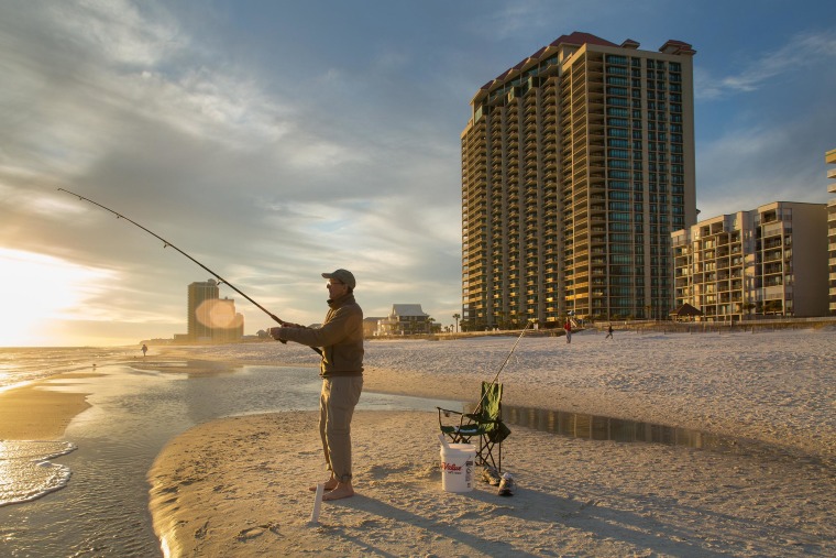 Image: The Phoenix West II condominium building, right, is one of dozens of buildings on the Gulf Coast beach in Orange Beach, Ala., that was moved from the highest-risk flood zone. Now insurance is optional for the owners of Phoenix West condos.