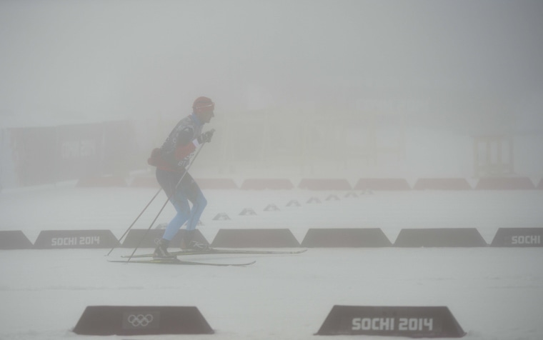 A Russian team's member skis as the Men's Biathlon 15 km Mass Start has been postponed for the second time due to bad weather condition at the Laura Cross-Country Ski and Biathlon Center during the Sochi Winter Olympics on Feb. 17, 2014, in Rosa Khutor, near Sochi. 