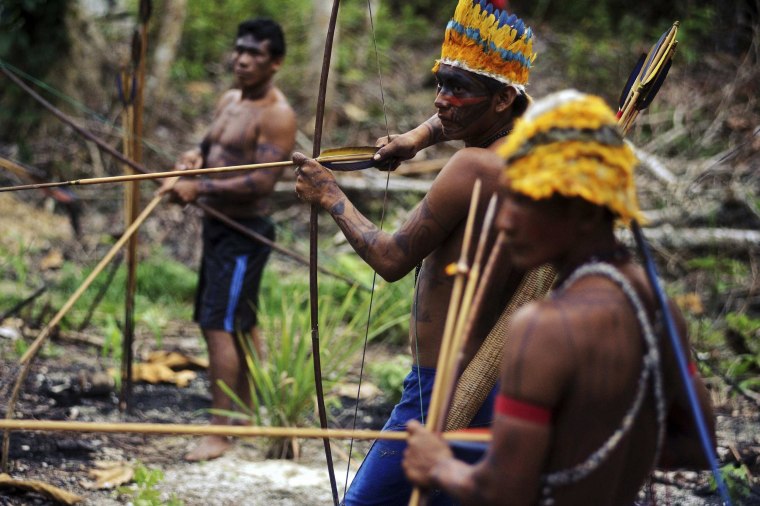 Image: Munduruku Indian warriors prepare themselves as they approach a wildcat gold mine in western Para state