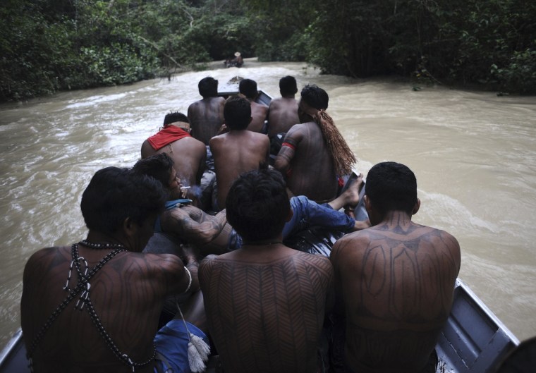 Image: Munduruku Indian warriors navigate the Das Tropas river as they search for illegal gold mines and miners in their territory in western Para state