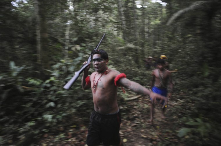 Image: Munduruku Indian warriors search for illegal gold mines and miners in their territory near the Das Tropas river in western Para state