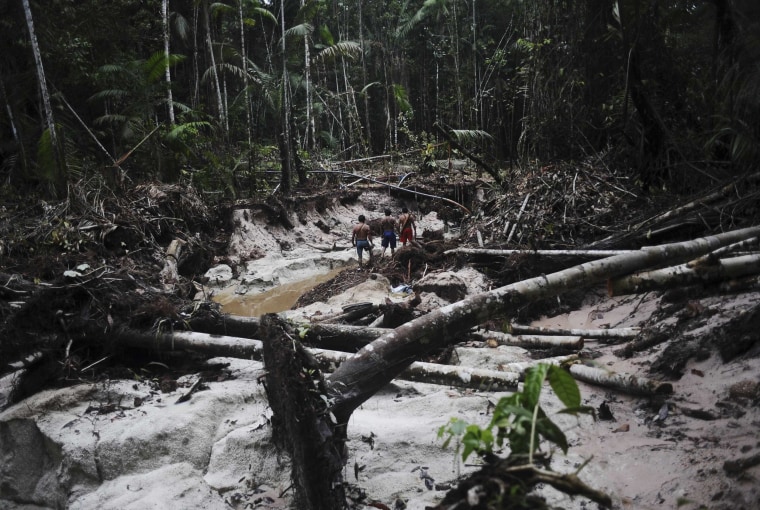 Image: Munduruku Indian warriors inspect a wildcat gold mine as they search for illegal gold mines and miners in western Para state