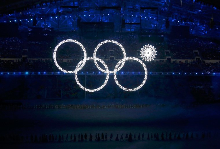 Image: Four of the five Olympic Rings are seen lit up at the start of the opening ceremony of the 2014 Sochi Winter Olympics