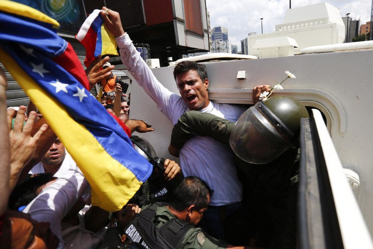 Image: Venezuelan opposition leader Leopoldo Lopez gets into a National Guard armored vehicle in Caracas