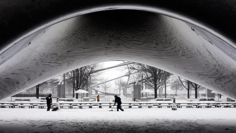Image: A worker clears snow near Chicago's Cloud Gate sculpture on Jan. 2.