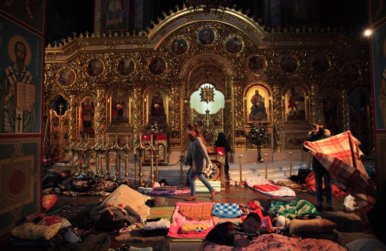 Image: People rest inside Mikhailovsky Zlatoverkhy Cathedral, which serves as a temporary shelter and a first-aid post for anti-government protesters, in Kiev