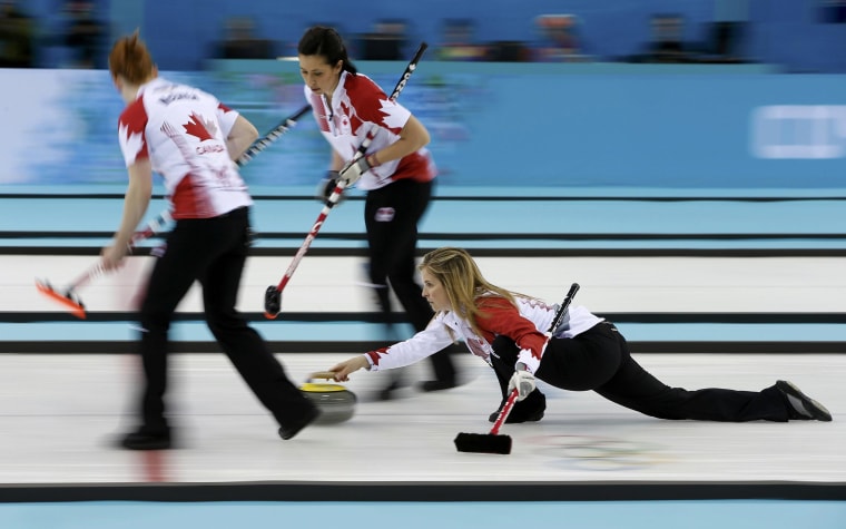 Image: Canada's McEwen and Officer prepare to sweep as Jones delivers a stone in their women's gold medal curling game against Sweden at the Ice Cube Curling Centre during the Sochi 2014 Winter Olympics