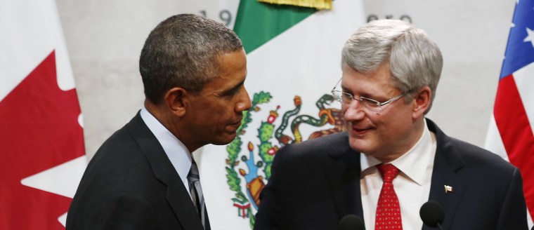 Image: U.S. President Barack Obama joins Canada's Prime Minister Stephen Harper before a trilateral meeting in Mexico