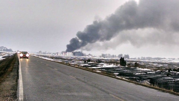 Image: A fire burns at a chemical storage shed at a small airport used by cropdusting planes in Northwood, Iowa