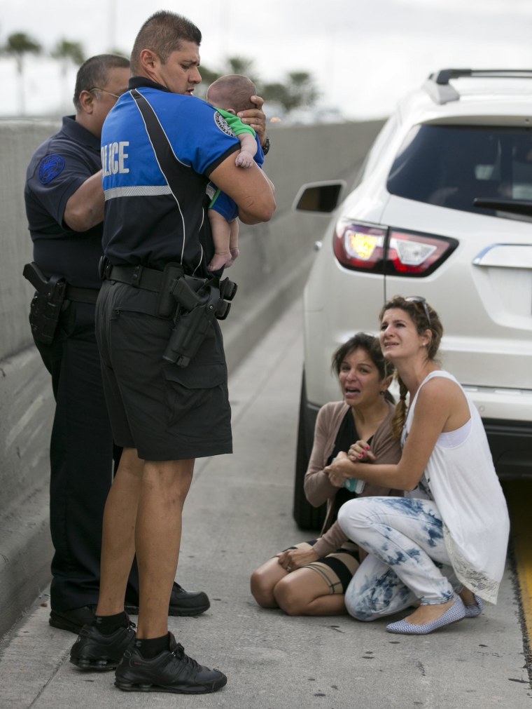 Image: Sweetwater officer Amauris Bastidas helps rescue a five-month-old baby boy