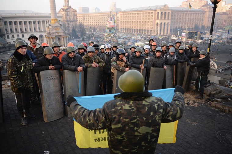 Image: Anti-government protesters man the barricades in Independence Square in Kiev on Friday.