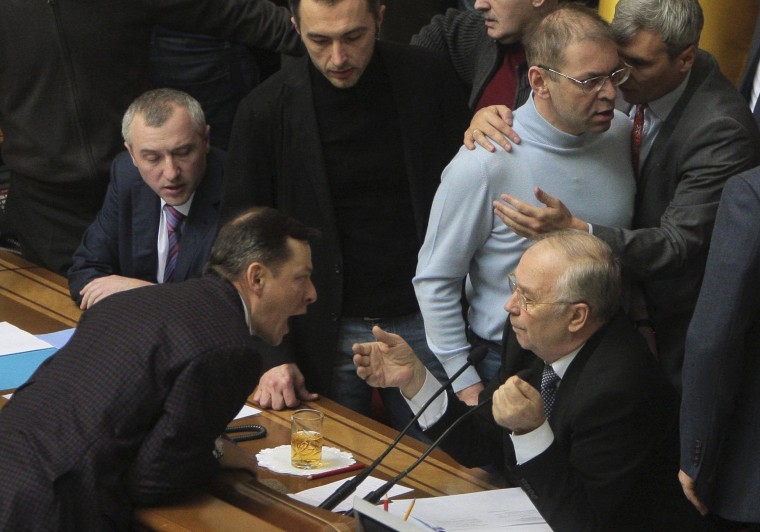 Image: Ukrainian deputies surround speaker Rybak during a session of parliament in Kiev