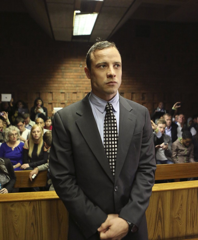 Image: Oscar Pistorius enters the dock before in court proceedings at the Pretoria Magistrates court