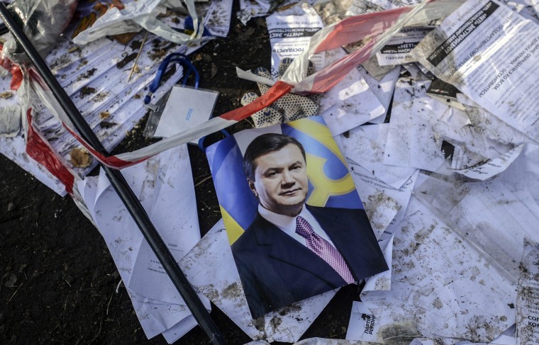Image: A picture of Ukraine's President Viktor Yanukovich is seen on the ground in Kiev