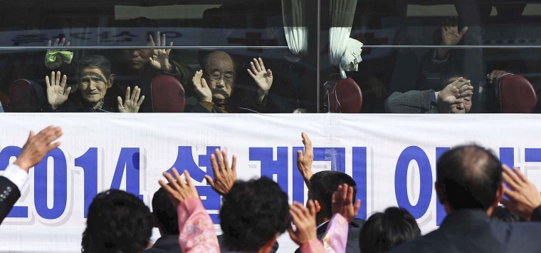 Image: South Korean visitors wave to their North Korean relatives before leaving on a bus for South Korea.