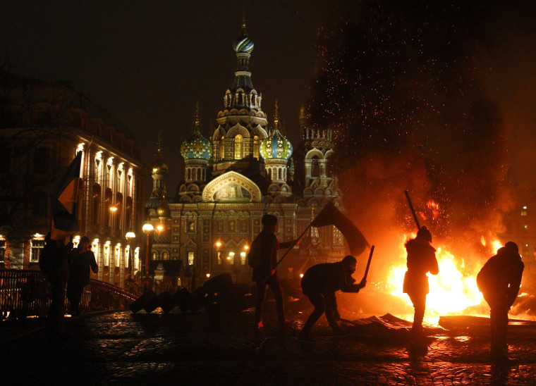 Image: Russian opposition activists hold protest in support of the revolution in Ukraine, burning car tires in the center of St Petersburg,