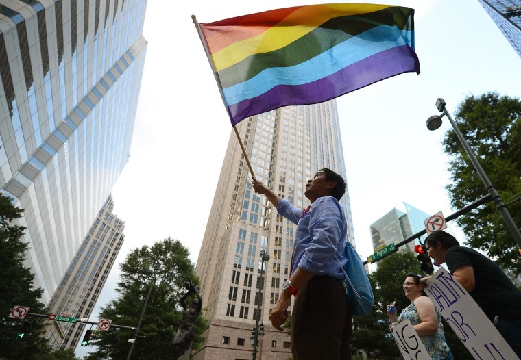 Image: A man waves a flag in Charlotte, N.C.