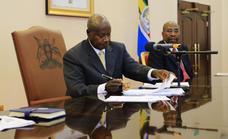 Image: Uganda President Yoweir Museveni signs an anti-homosexual bill into law at the state house in Entebbe