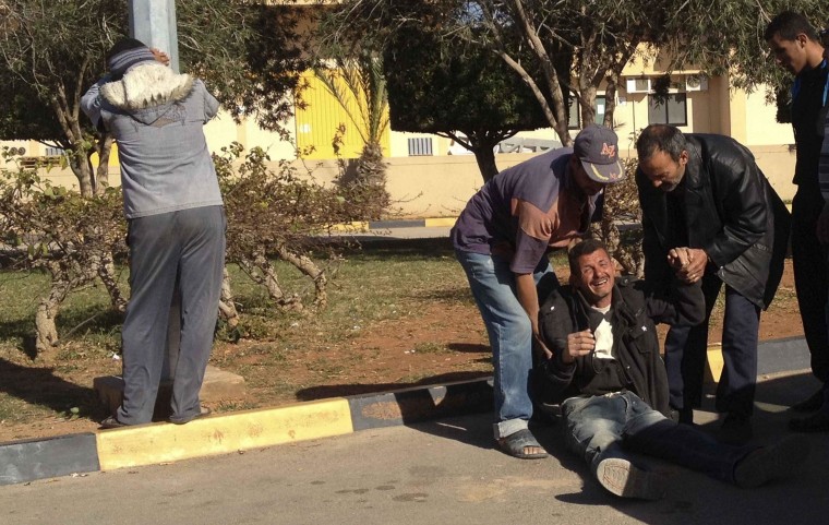 Image: Relatives of seven Egyptians killed in a beach react outside the morgue in Benghazi