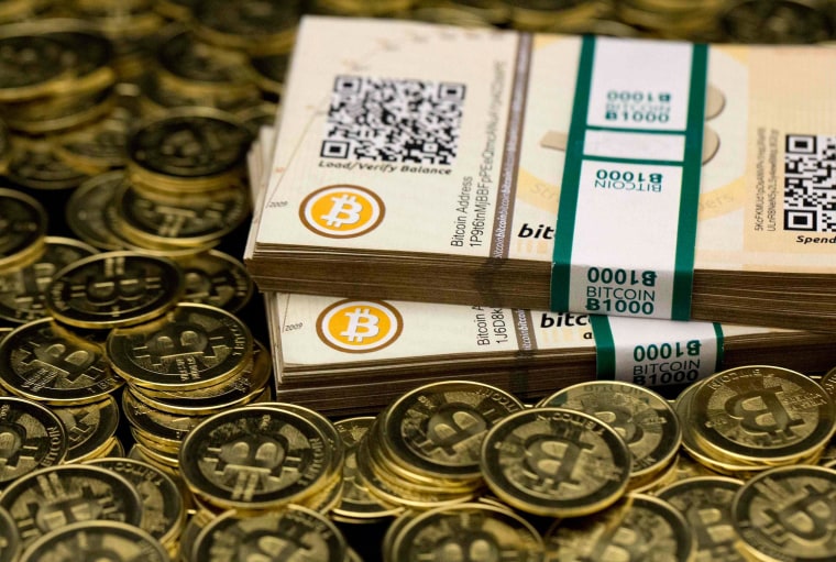 Image: Some of Bitcoin enthusiast Mike Caldwell's coins and paper vouchers often called "paper wallets" are pictured at his office in Sandy, Utah