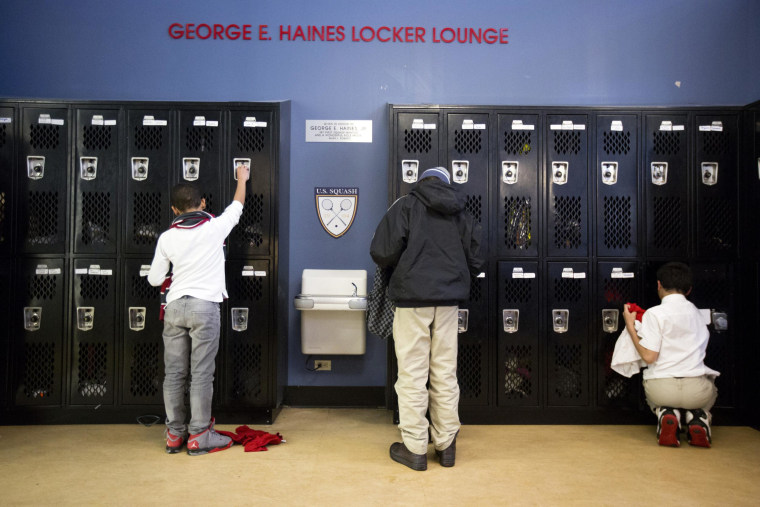 Image: Youths get their things from lockers before squash practice at the Lenfest Center