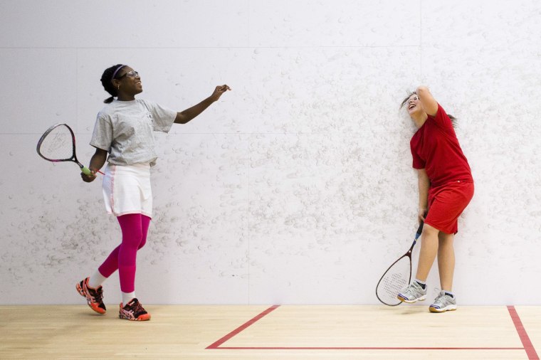 Image: Aaliyah Galloway, 12, left, and Melliah Santos, 12, laugh as they play squash at the Lenfest Center