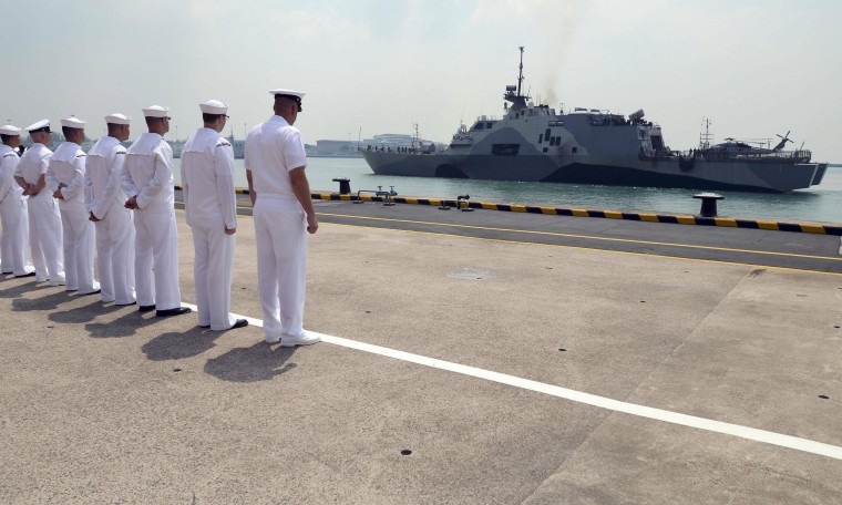 Image: U.S. Navy sailors look at the littoral combat ship USS Freedom as it arrives in Changi Naval Base