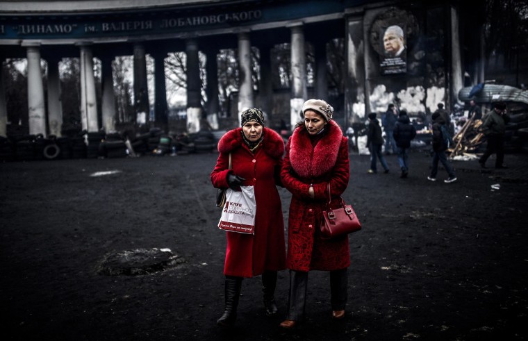Image: Women walk in front of the Dinamo Kiev soccer stadium