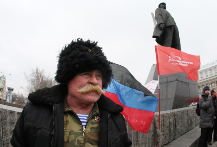 Image: Ukrainian Communist Party activist near Lenin monument in Donetsk