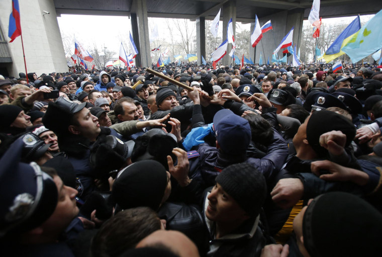 Image: Pro-Russian protesters, left, clash with Crimean Tatars