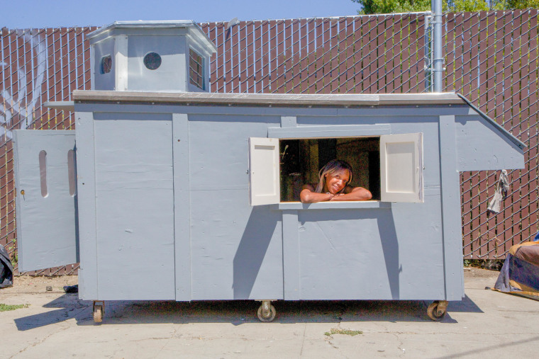 A woman is seen in a shelter built by California artist Gregory Kloehn.