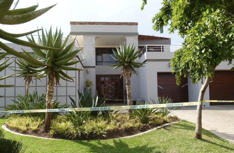 Image: Police crime scene tape marks off the Pretoria home of South African "Blade Runner" Oscar Pistorius