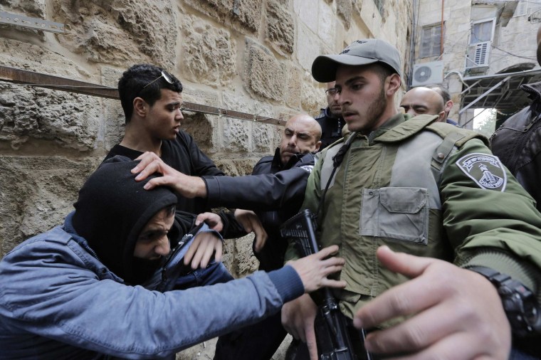 Image: Israeli police and border police officers scuffle with a Palestinian in Jerusalem's Old City