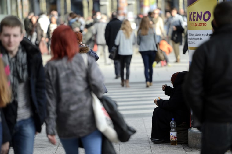 Image: A person begs pedestrians for money on March 6, 2013 in Frankfurt am Main, Germany