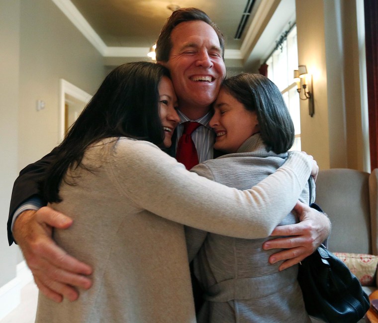 Image: Cleopatra de Leon and Nicole Dimetman hug attorney Neel Lane