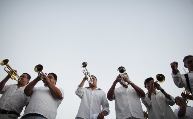 Image: A brass band plays songs known to be favorites of Joaquin "Chapo" Guzman during a march in Culiacan