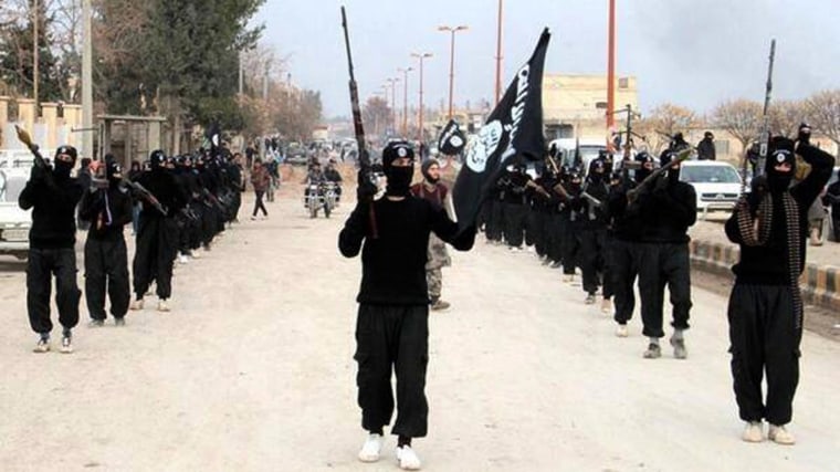 Image: ISIL fighters march in Raqqa, Syria